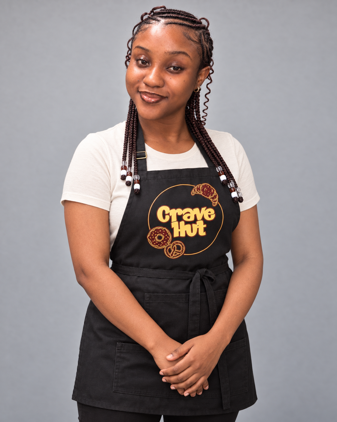 The owner and baker behind Crave Hut wearing her bakery apron
